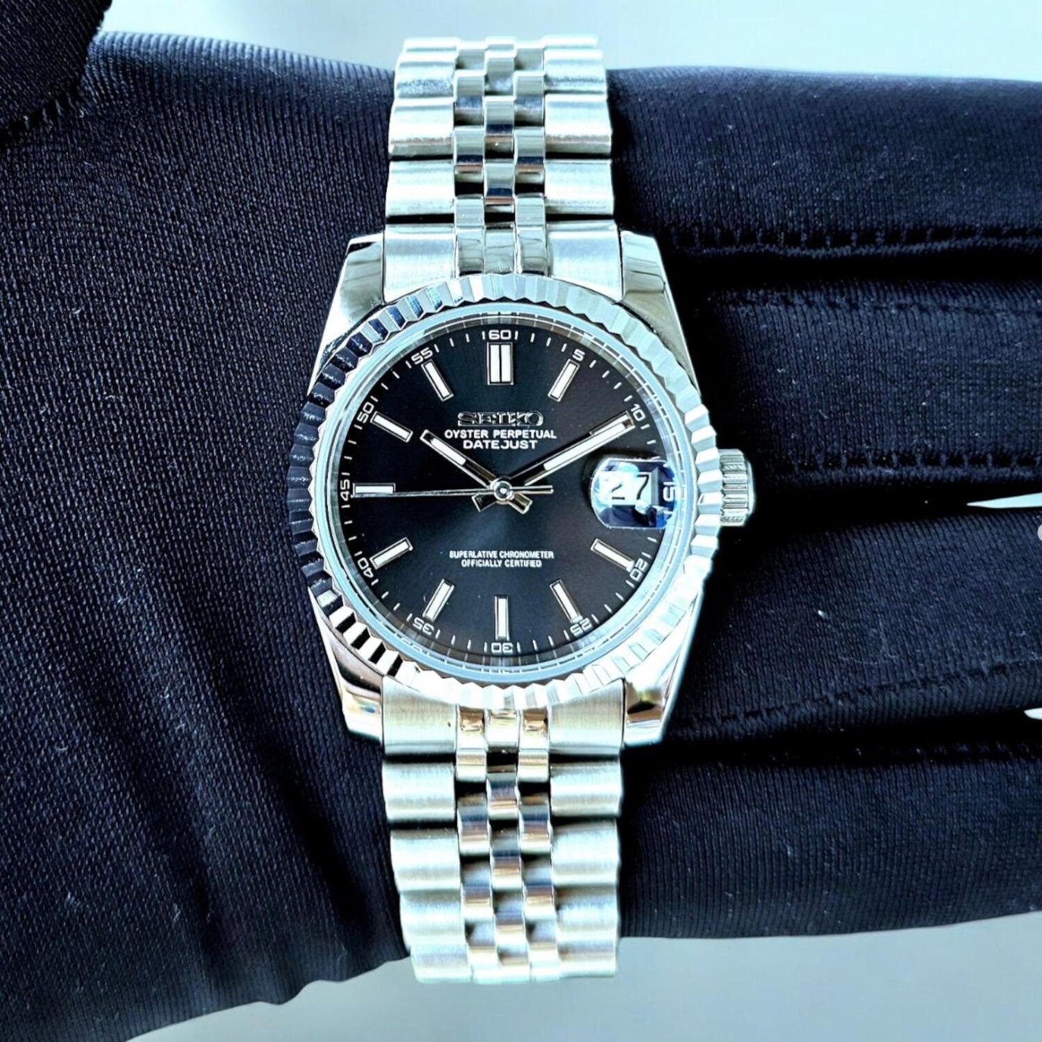 Seiko Mod Datejust Black Dial on black glove with silver Jubilee bracelet front view