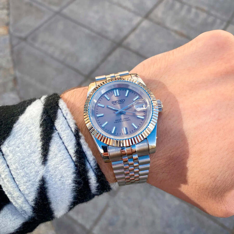 Seiko Mod Datejust wrist shot outdoors showing champagne dial and stainless steel Jubilee bracelet