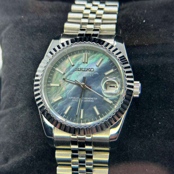 Seiko Mods Datejust front right three quarter angle of Datejust Cosmos showing iridescent black dial and Jubilee bracelet