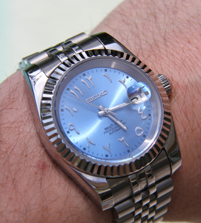 Seiko Mod Datejust Ice Blue Arabic watch on wrist with brushed steel bracelet and fluted bezel