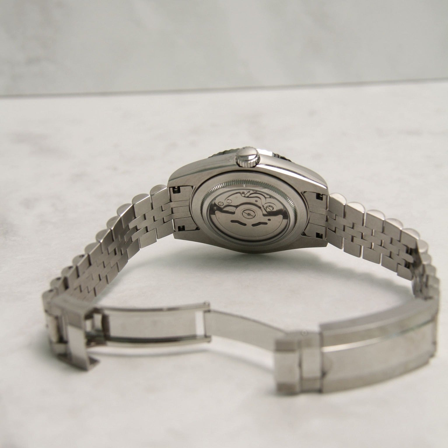Seiko Mods Datejust Mint Green Arabic Clear Case Movement
Rear view showing transparent caseback and visible automatic movement of the watch