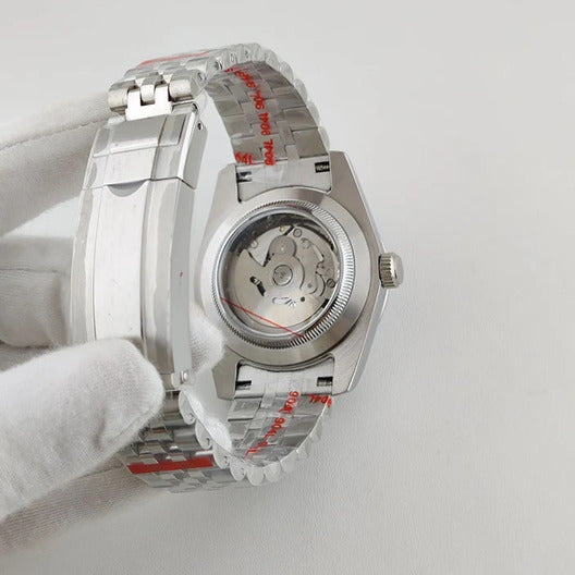 Seiko Mod Datejust White Textured Arabic clear case movement revealing automatic rotor through transparent exhibition back.