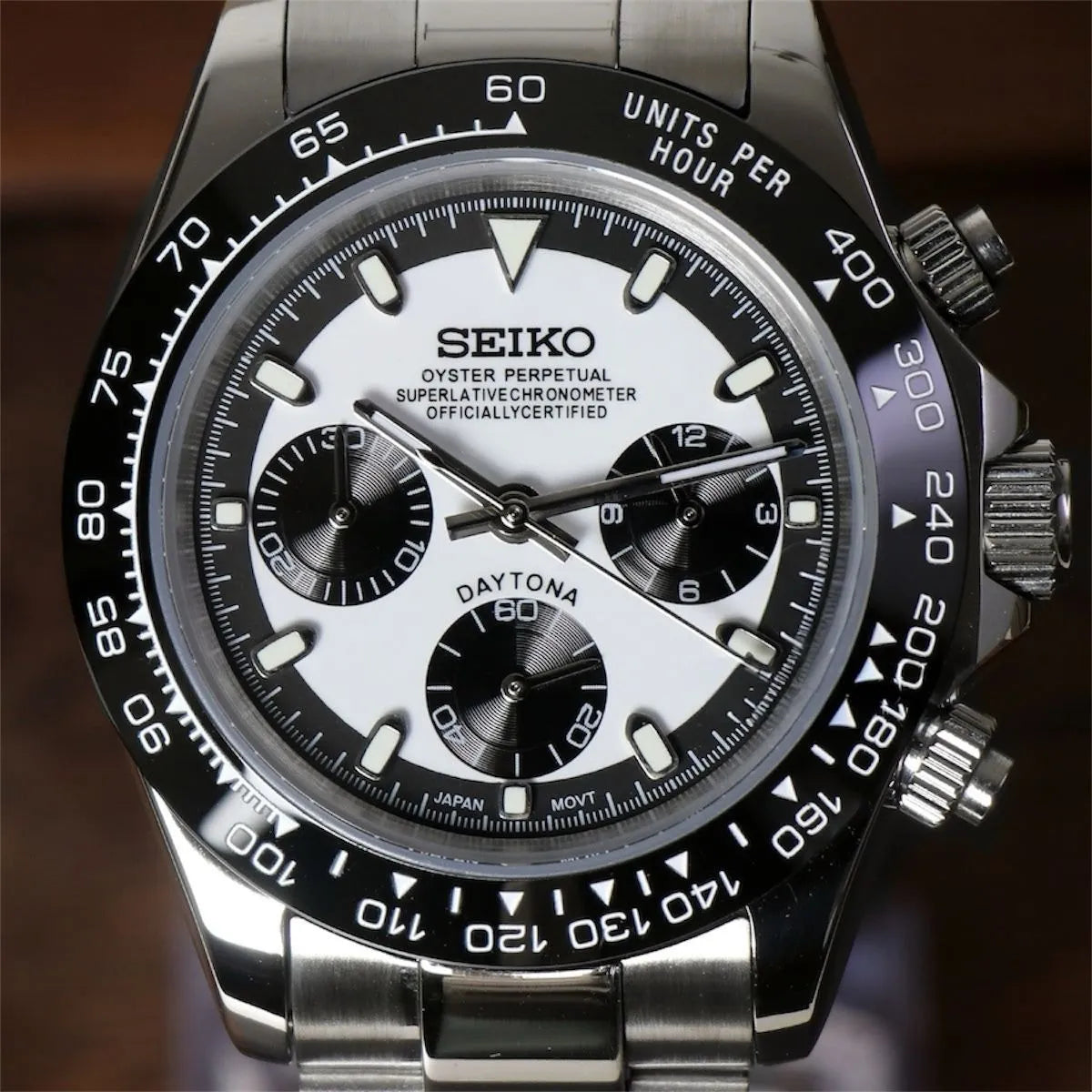 Close up of Seiko Mod Daytona dial with black ceramic bezel, crisp white background and bold contrasting black subdials