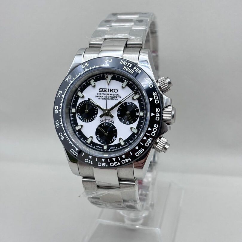 Seiko Mod Daytona with black ceramic bezel, white dial and black subdials shown in right angled view on steel bracelet.