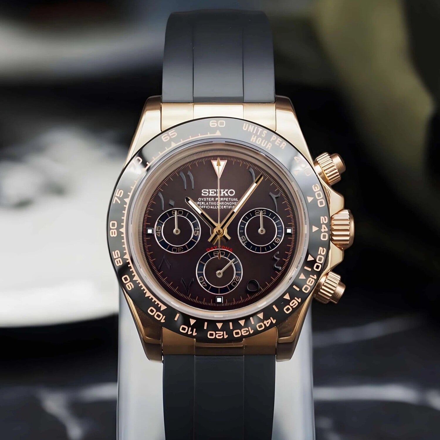 Seiko Mod Daytona with brown Arabic dial and rose gold case, shown with a black rubber strap in full frontal view.