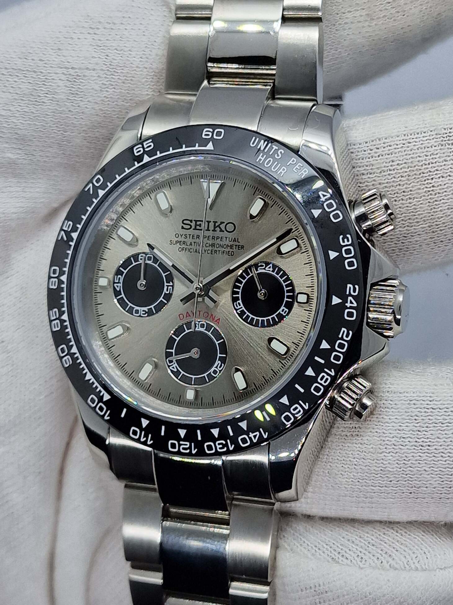 Right side close up of Seiko Mod Daytona champagne dial, luminous markers and tachymeter bezel.