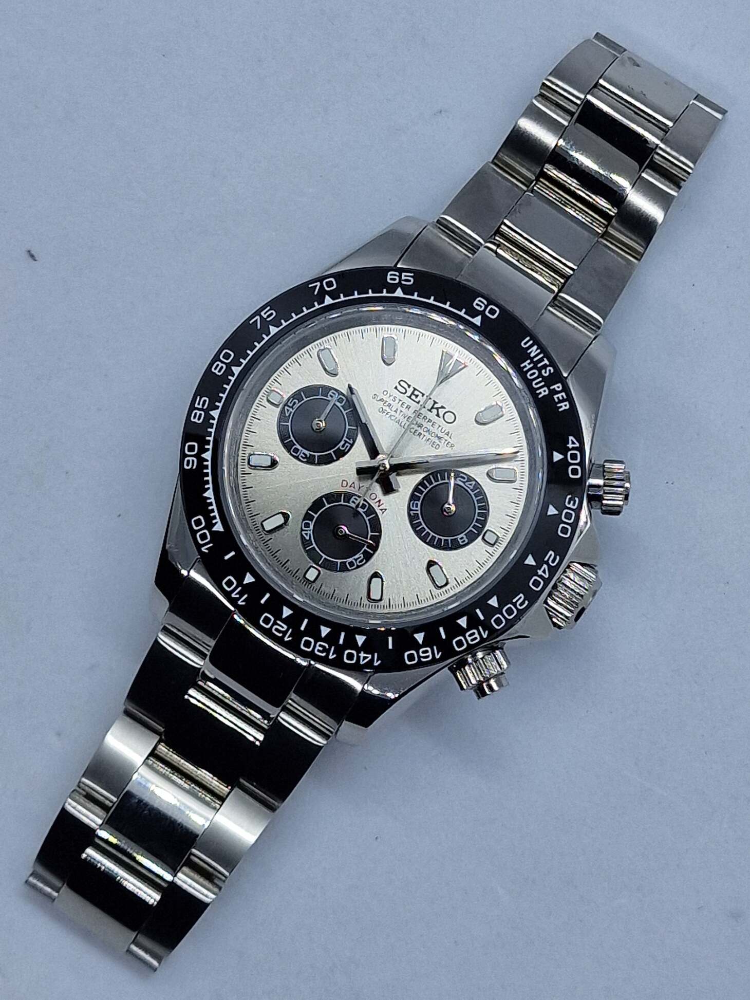 Top view of Seiko Moddys Daytona featuring a champagne sunburst dial, black subdials, ceramic bezel and stainless steel bracelet