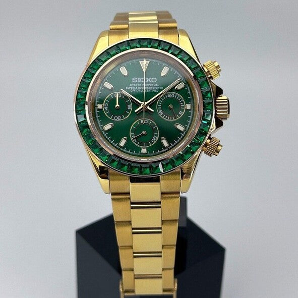 Seiko Moddys Daytona Green Emerald front view with polished gold bracelet, emerald-set bezel and deep green dial.