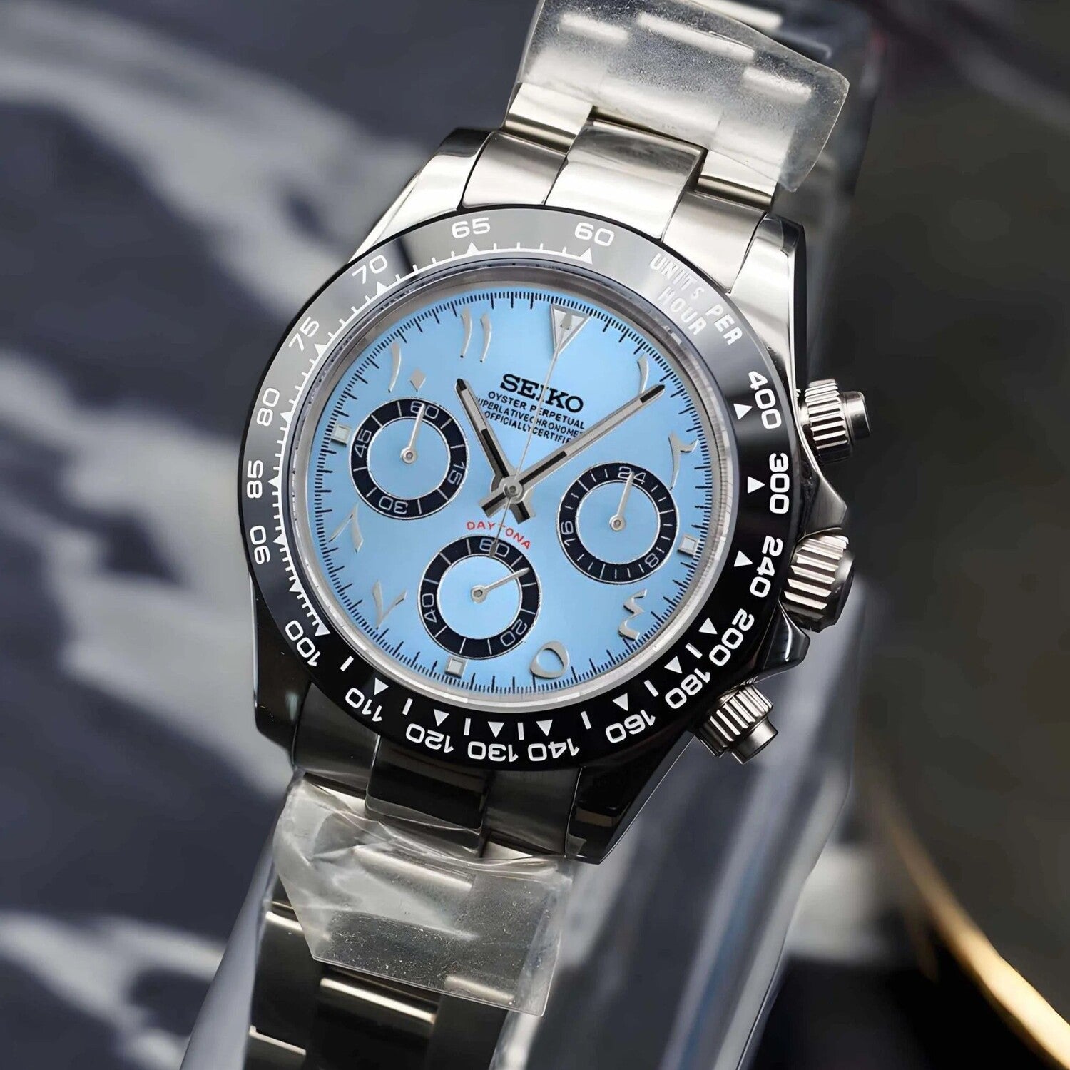 Right angled view of Seiko Mod Daytona ice blue Arabic dial with black ceramic bezel and steel bracelet.