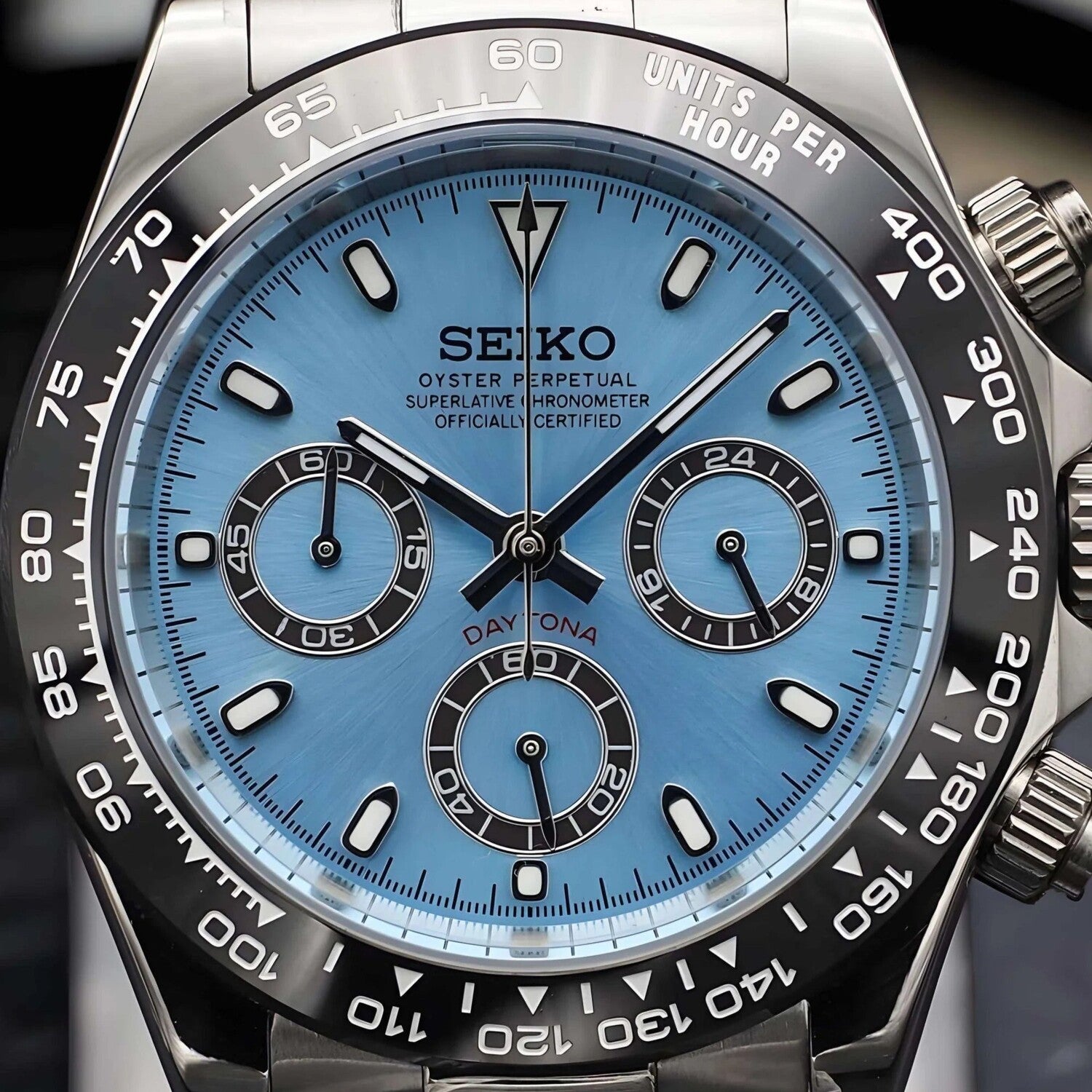 Close up of Seiko Mod Daytona Ice Blue dial with black subdials, luminous markers and tachymeter bezel.