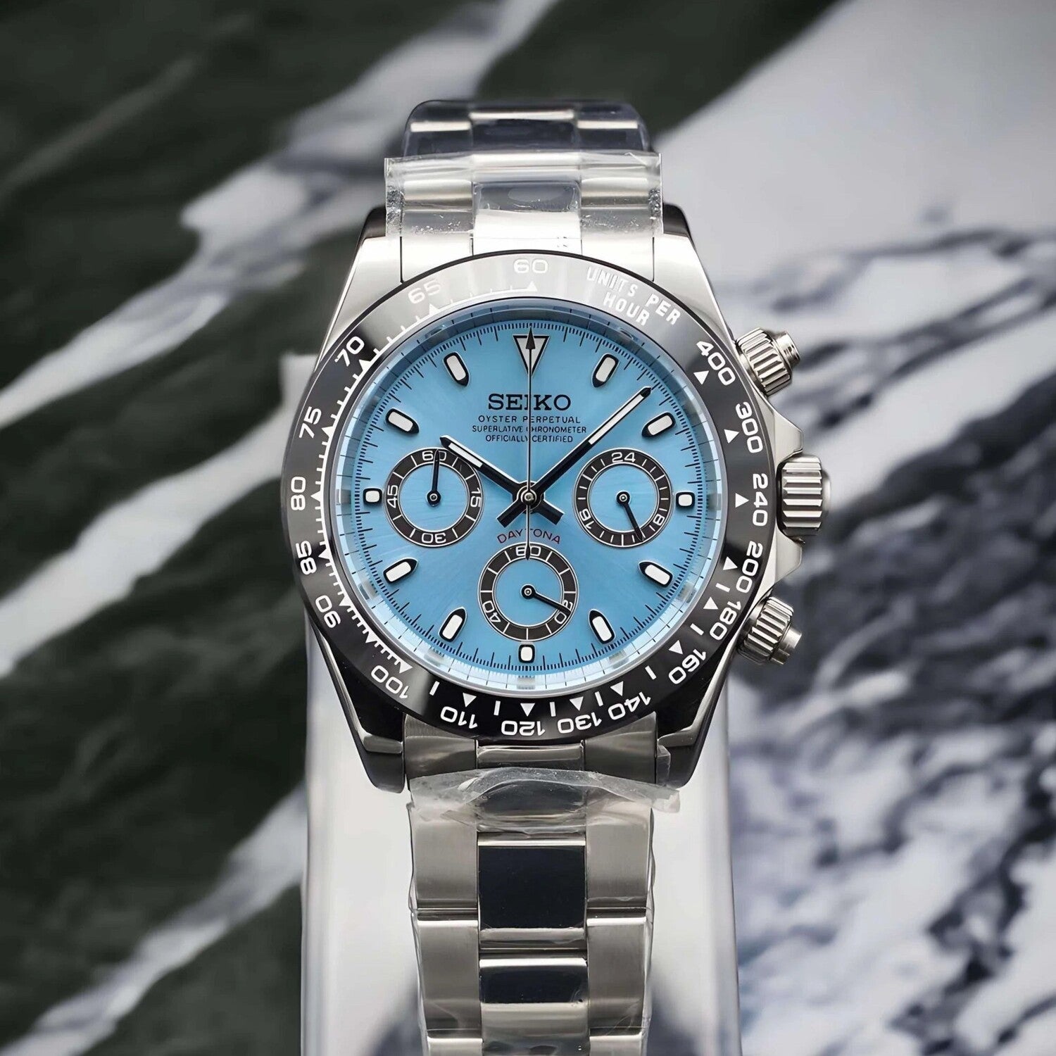 Front view of the Seiko Mod Daytona featuring an ice blue dial, contrasting black subdials, polished stainless steel case, black tachymeter bezel, and matching steel bracelet.
