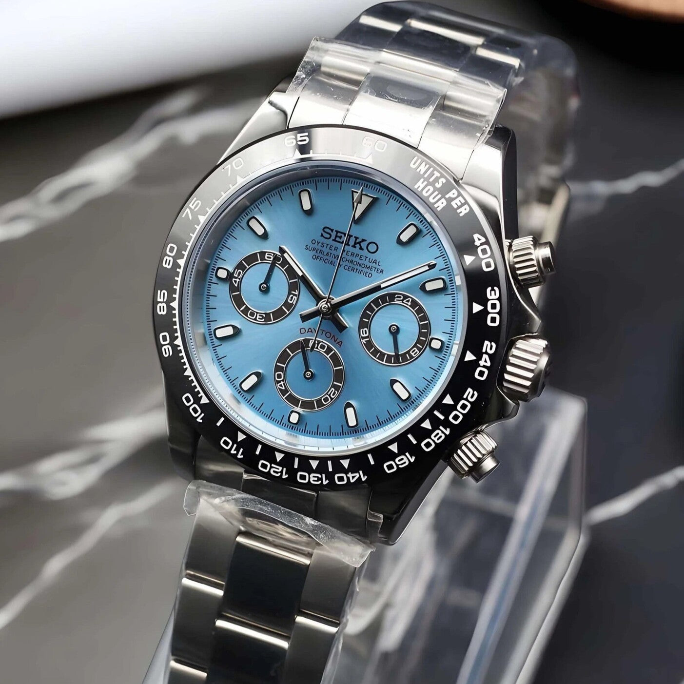 Angled view of Seiko Mod Daytona Ice Blue with vivid blue dial, black subdials and steel bracelet.