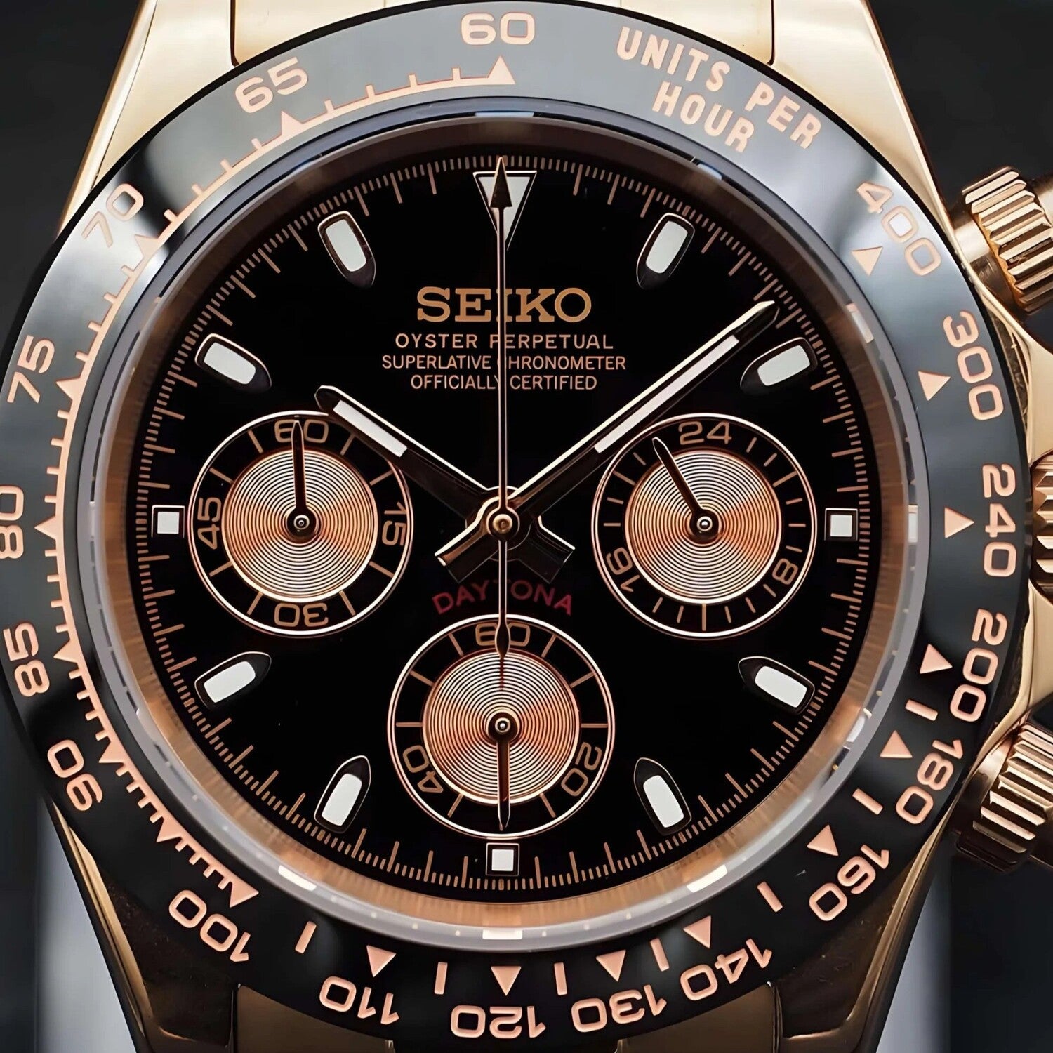 Close up view of the Seiko Mod Daytona in rose gold with black dial, golden subdials, and ceramic bezel.