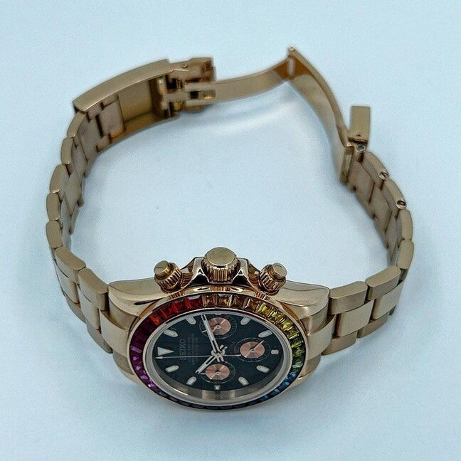 Angled top view of the Seiko Mod Daytona Rose Gold Rainbow, focusing on the crown, pushers, and rainbow gemstone bezel with rose gold bracelet.