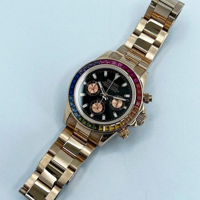 Top view of the Seiko Mod Daytona Rose Gold Rainbow laid flat, with a clear view of its black dial, rainbow gemstone bezel, and rose gold bracelet.