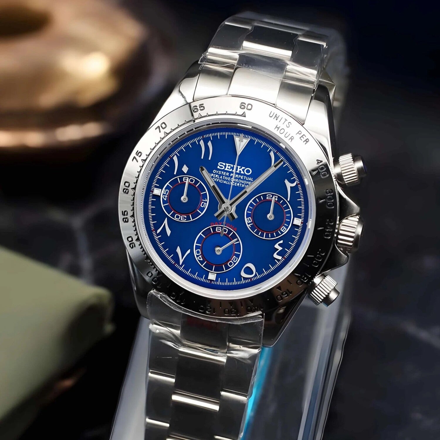 Seiko Mod Daytona Royal Blue Arabic angled view showcasing vivid blue dial with Arabic numerals, silver bezel, and polished steel bracelet.