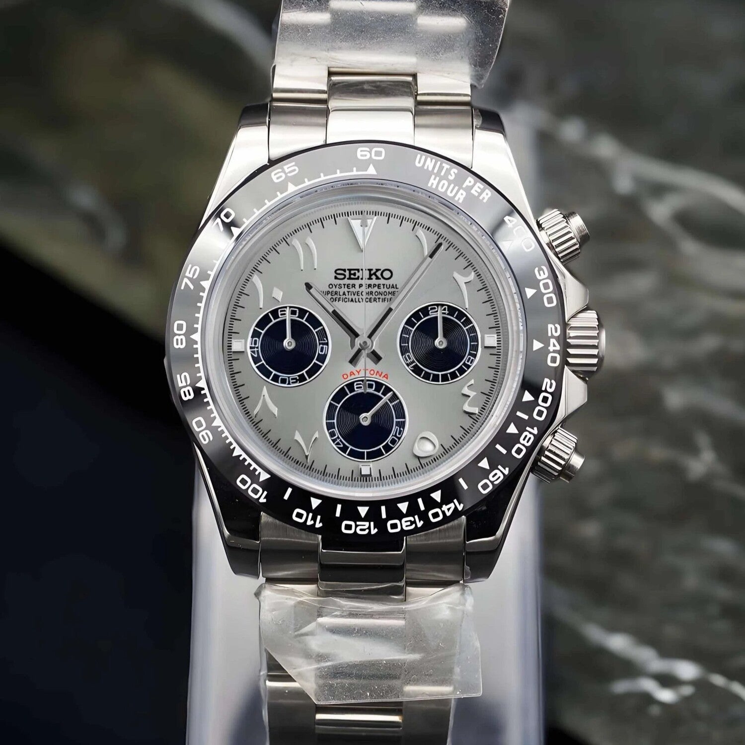Seiko Mods Full front view. Watch displayed upright with silver Arabic dial, black ceramic bezel, and stainless steel bracelet.