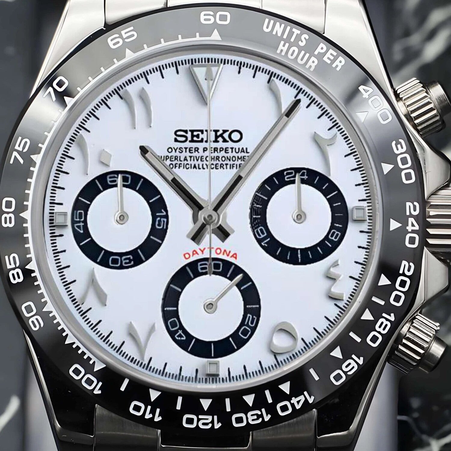 Close up of Seiko Mod Daytona with white Arabic dial black ceramic bezel and stainless steel case