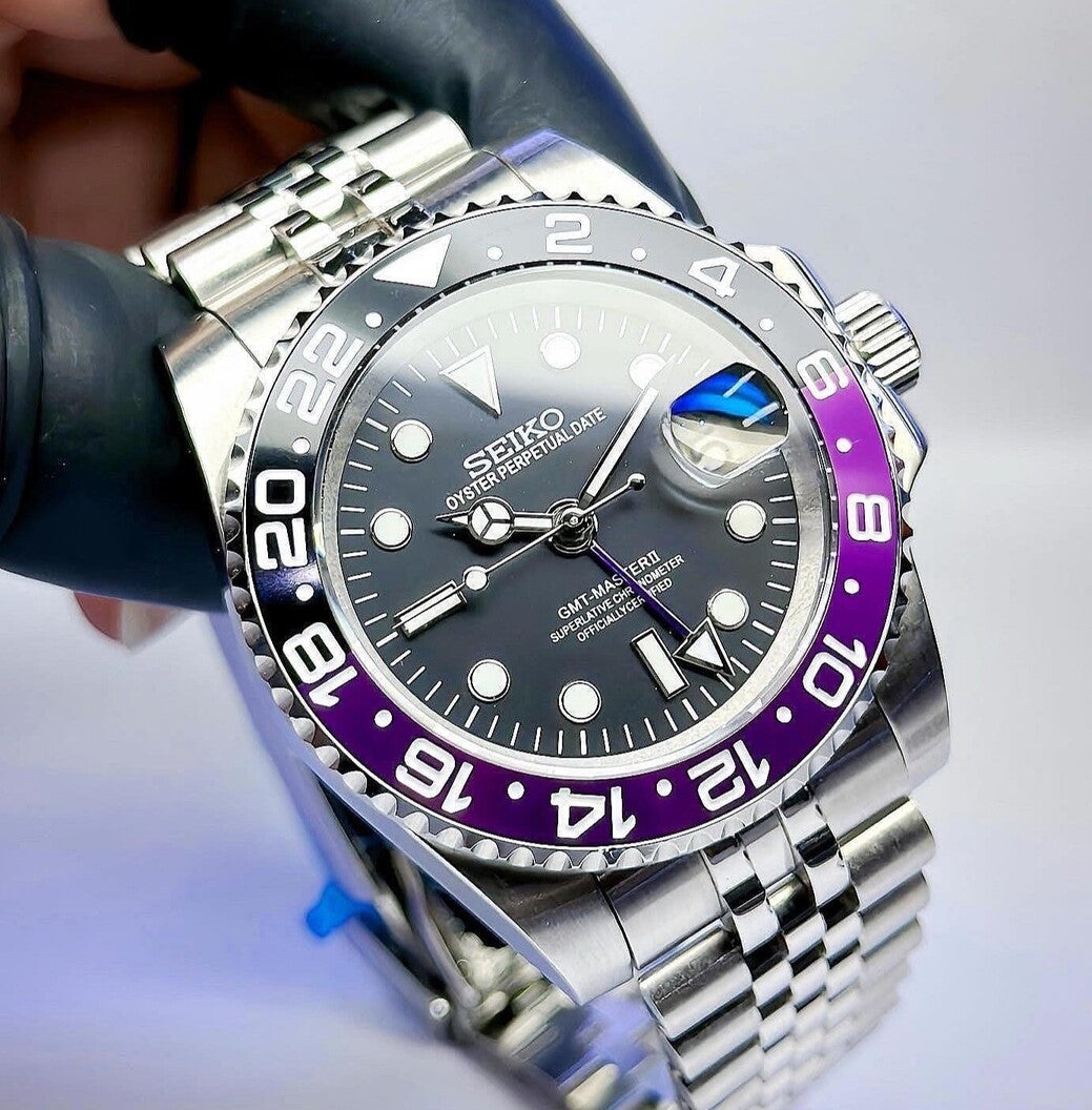Angled front view Seiko Mod GMT Joker showing glossy bezel reflection and magnified date lens