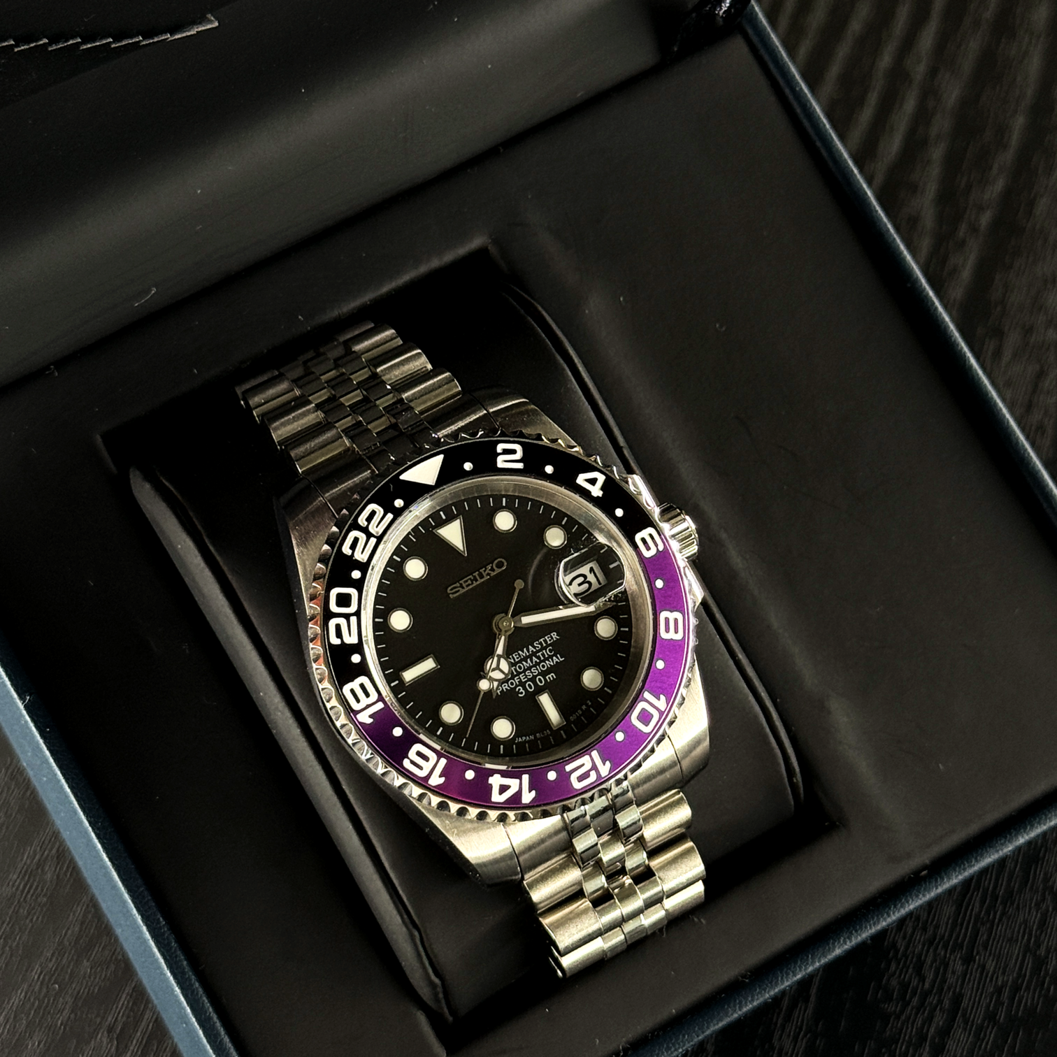 Box view Seiko Mod GMT Joker resting in presentation case showing bracelet alignment and dial contrast