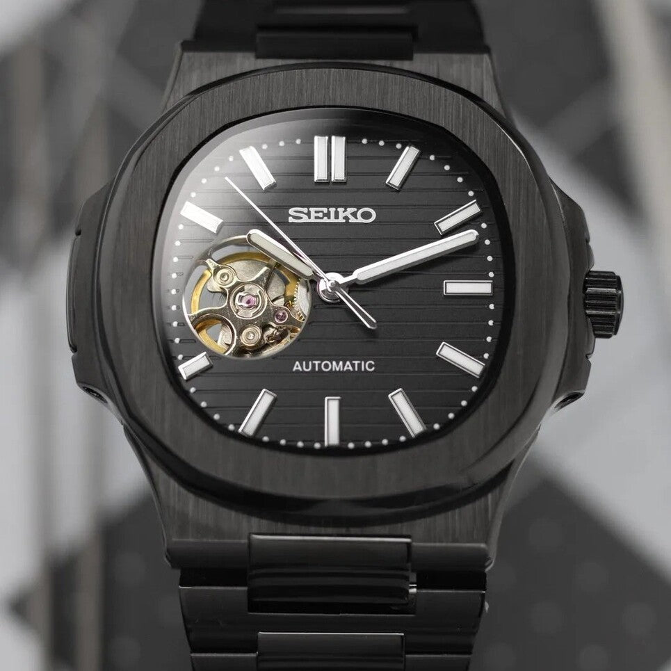 Tilted front view Seiko Mod Nautilus All Black Open Heart focusing on depth and metallic texture