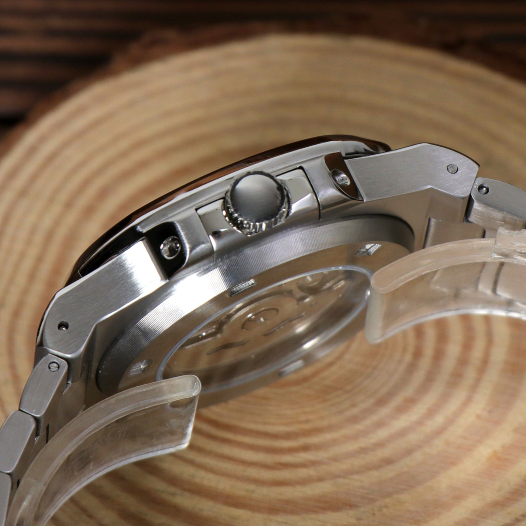 Side view of Seiko mod Nautilus cream revealing crown and brushed steel case on wooden surface