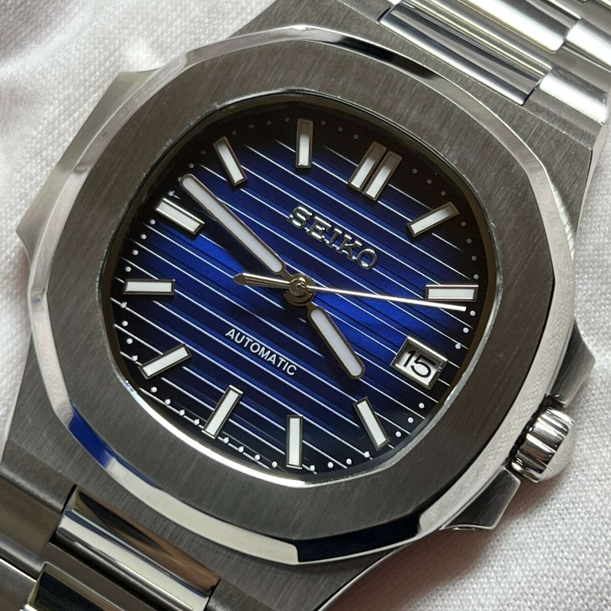 Right angled view of Seiko mod Nautilus royal blue edition highlighting metallic blue dial and polished edges