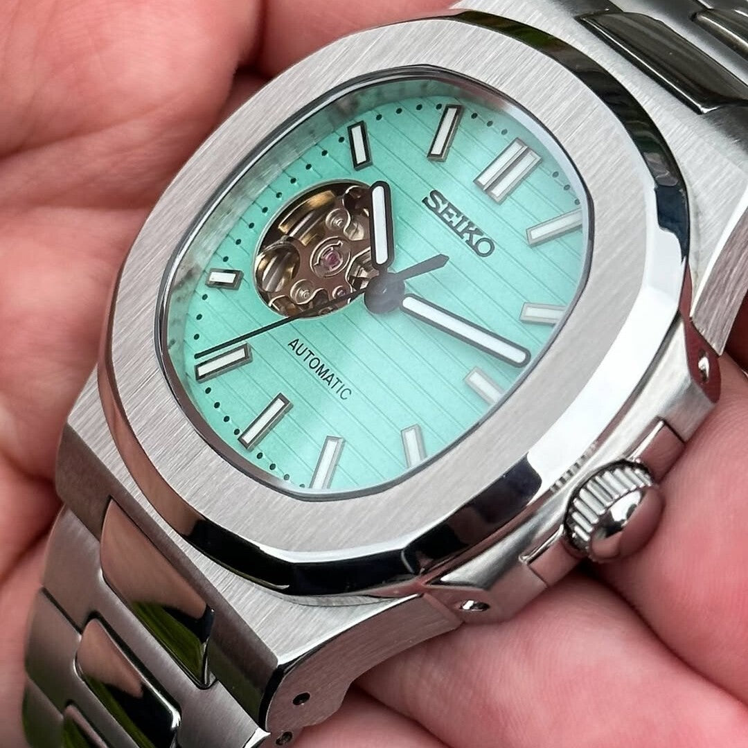 Right-angled close-up Seiko Mod Nautilus Tiffany Open Heart showcasing brushed bezel and crown detail
