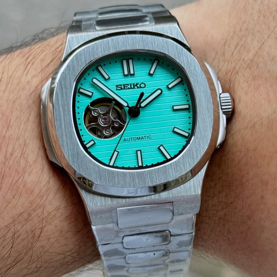 Wrist shot Seiko Mod Nautilus Tiffany Open Heart illustrating luminous turquoise dial contrast on wrist
