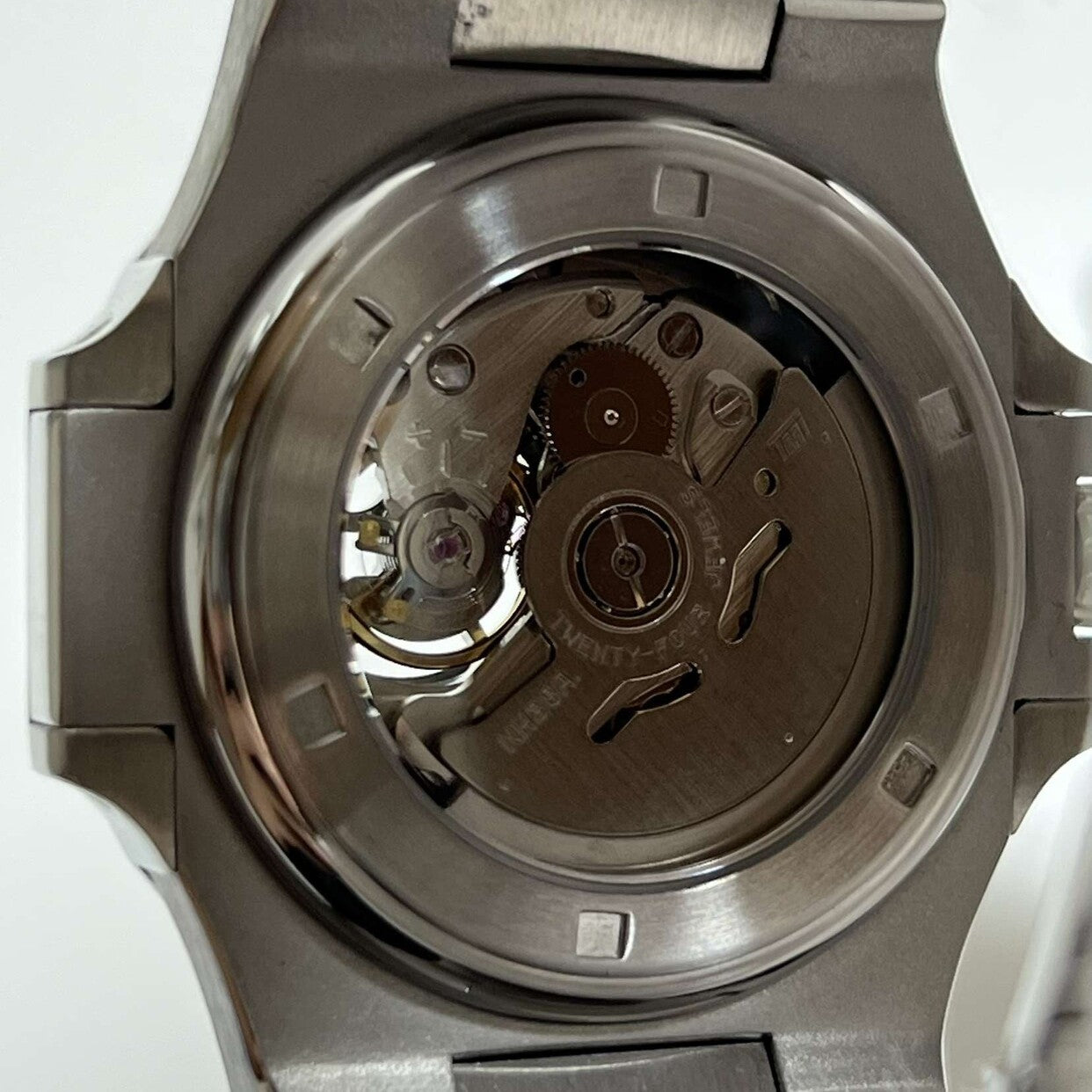 Close-up rear view Seiko Mod Nautilus Royal Blue Open Heart displaying visible rotor and movement through crystal back