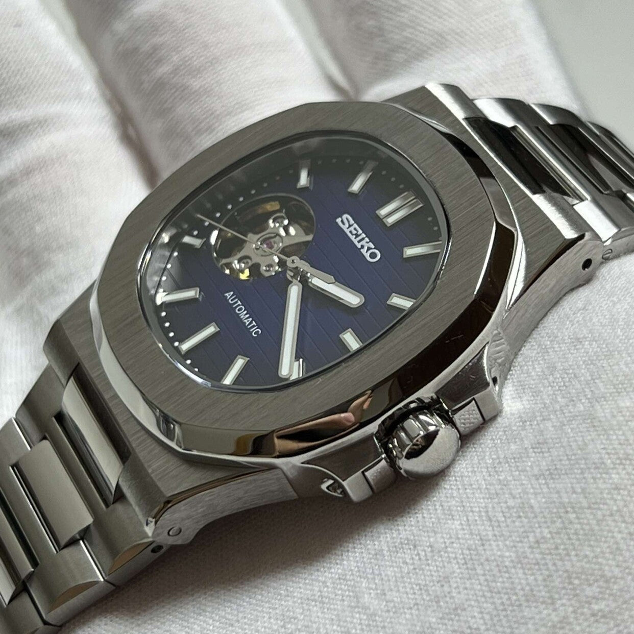 Side view Seiko Mod Nautilus Royal Blue Open Heart capturing depth of case and bracelet integration