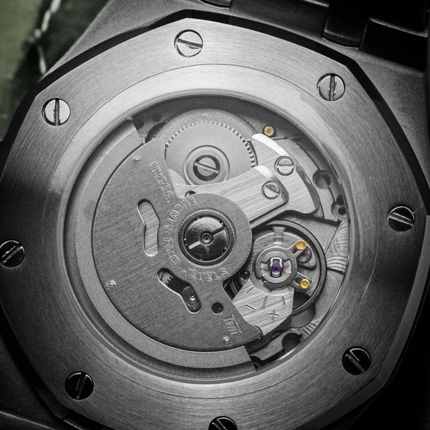 Close up view of the Seiko Mod Royal Oak brown Arabic edition showcasing the Seiko NH35A automatic movement through the transparent case back.