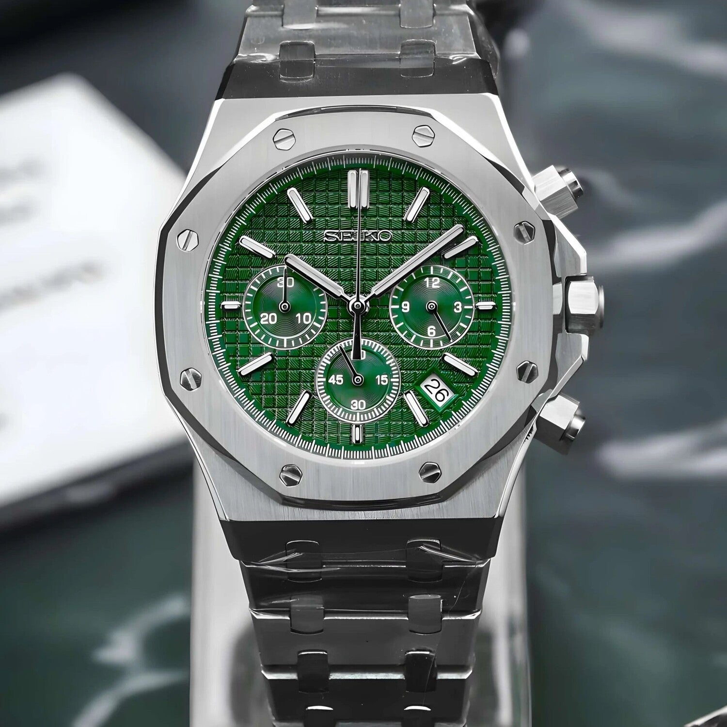 Front view of the Seiko Mod Royal Oak chronograph showcasing a striking green textured dial, three coordinated green subdials, brushed stainless steel octagonal bezel with polished screws, and integrated steel bracelet.