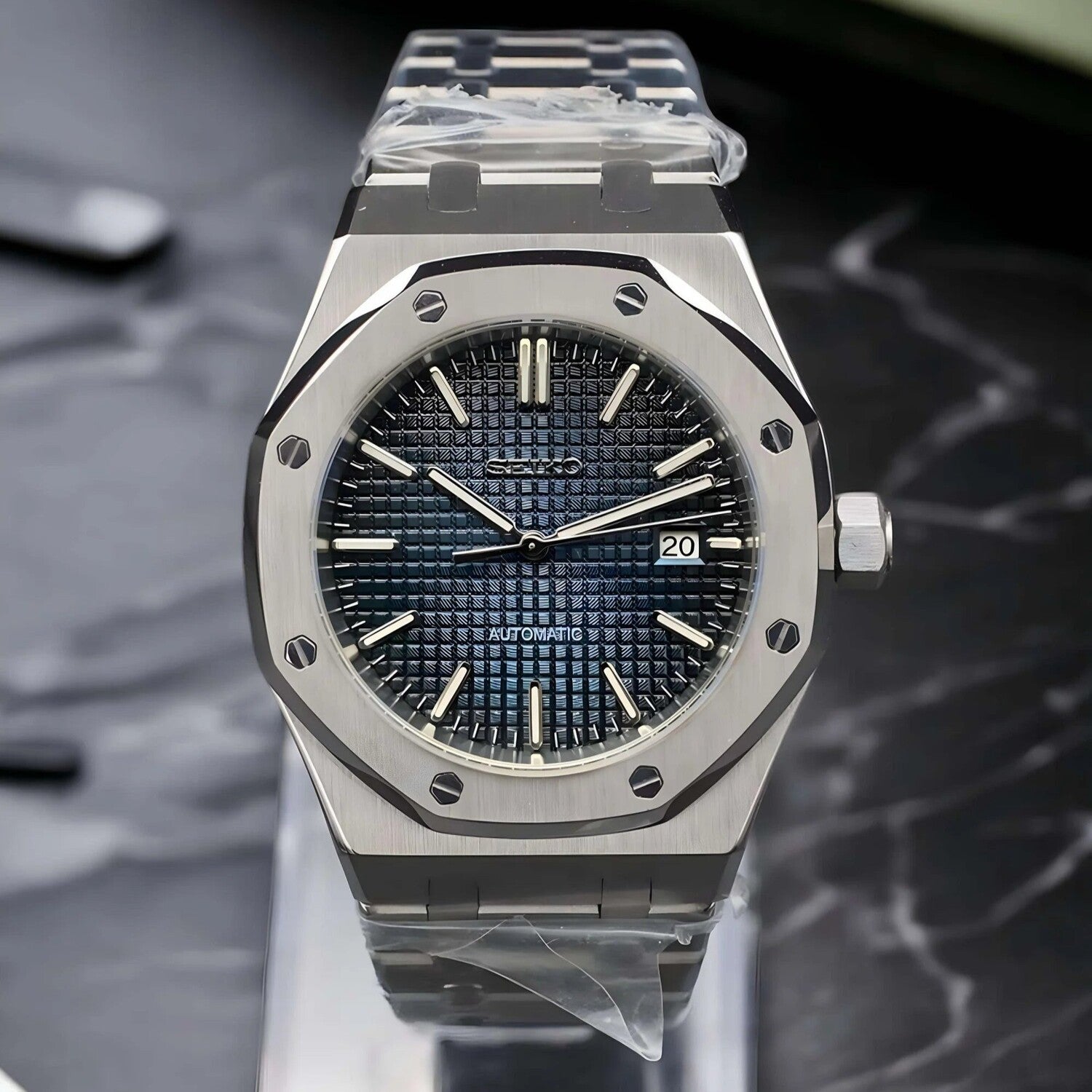 Front view of the Seiko Mod Royal Oak automatic watch with navy blue waffle pattern dial, stainless steel case, and date display at three o’clock
