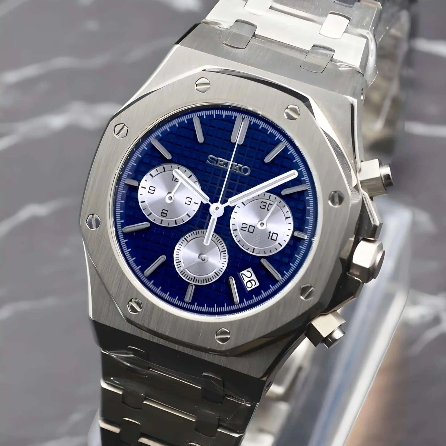 Right three quarter view of the Seiko Mod Royal Oak VK63 chronograph with blue textured dial, three silver subdials, sapphire crystal with anti-reflective finish, brushed stainless steel case, and integrated bracelet