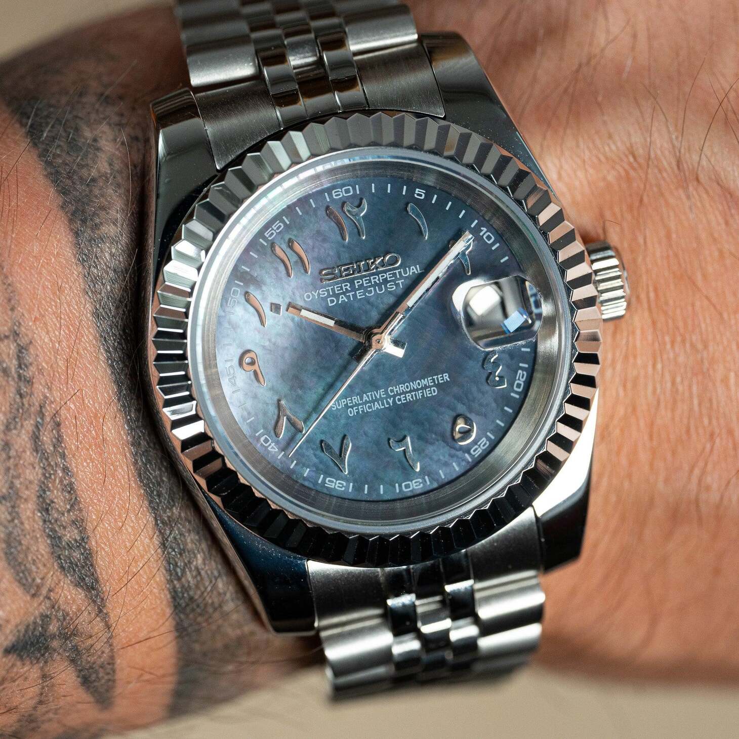 Wrist shot of Seiko Mod Datejust Cosmos Arabic with iridescent dial and Arabic numerals in natural light