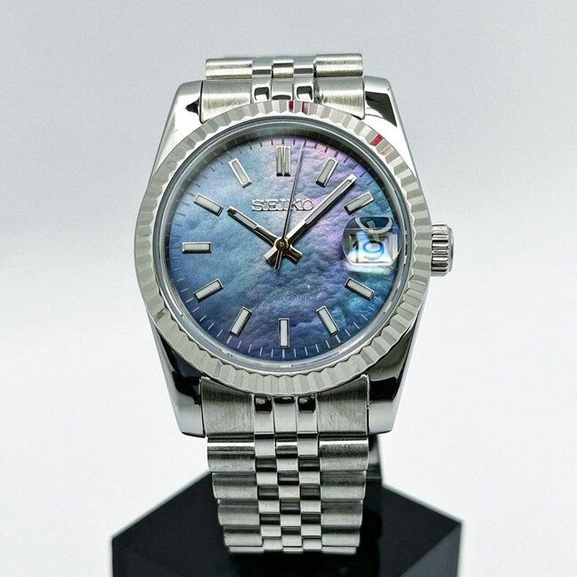 Seiko Mods  Datejust direct front view highlighting the shimmering blue green mother of pearl dial and date magnifier window