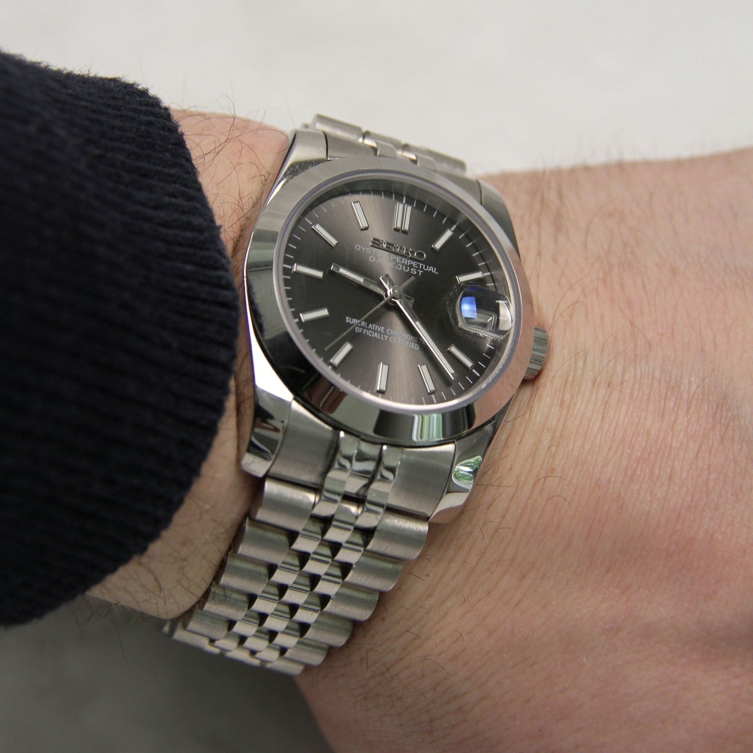 Seiko Mods Datejust Grey Smooth Bezel wrist view showing brushed links and polished case reflection