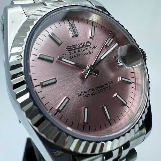 Front close up of Seiko Mod Datejust with metallic pink dial and polished fluted bezel