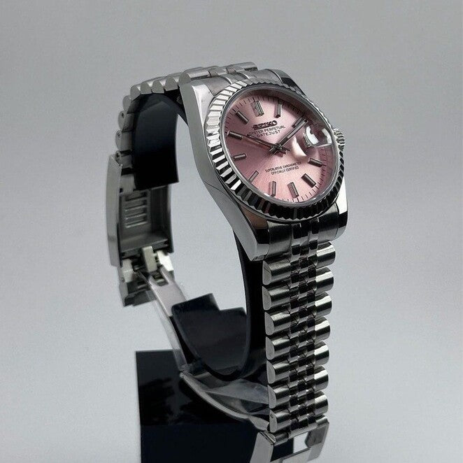 Left angled view of Seiko Mod Datejust showing pink sunburst dial and fluted steel bezel