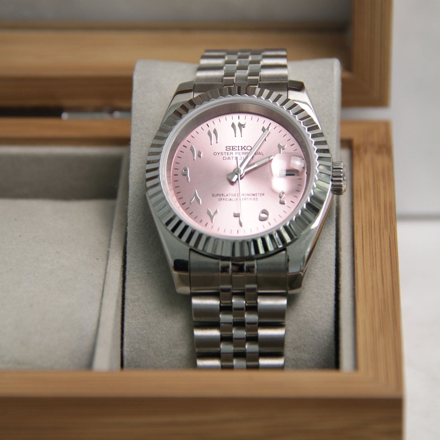 Seiko Mods Datejust Rose Arabic resting in beige bamboo watch box showing full dial