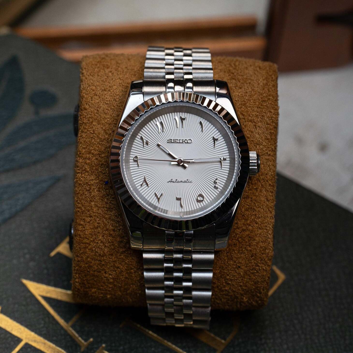 Seiko Mod Datejust White Textured Arabic on cushion highlighting dial texture and numerals.