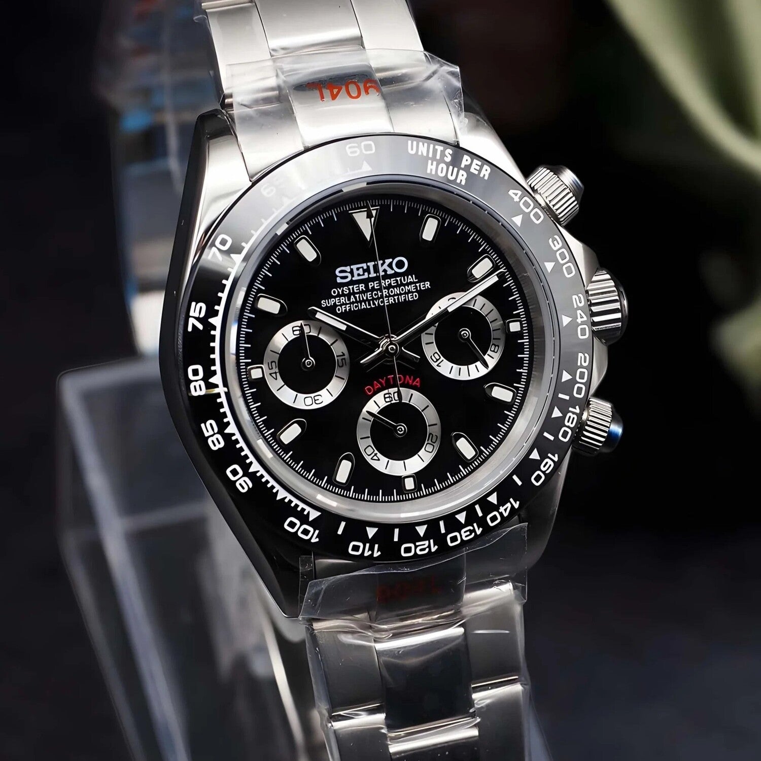 Front left angle view of the Seiko Mod Daytona homage in stainless steel, featuring a black dial with contrasting silver subdials, tachymeter bezel and polished chronograph pushers, captured in sharp detail to emphasize the sporty yet luxurious character of the watch