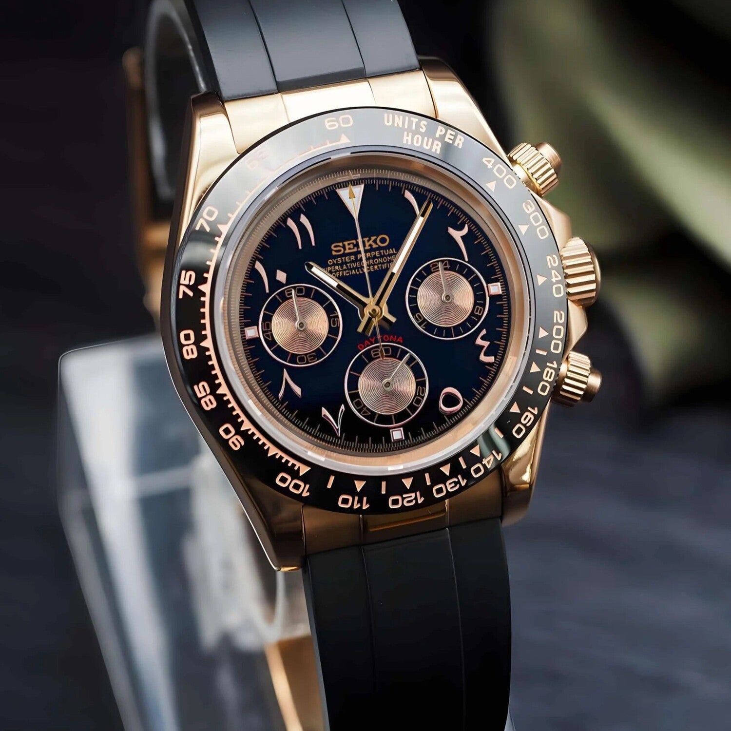Seiko Mod Daytona Rose Gold Arabic left side view with black dial, gold subdials, tachymeter bezel and black rubber strap.
