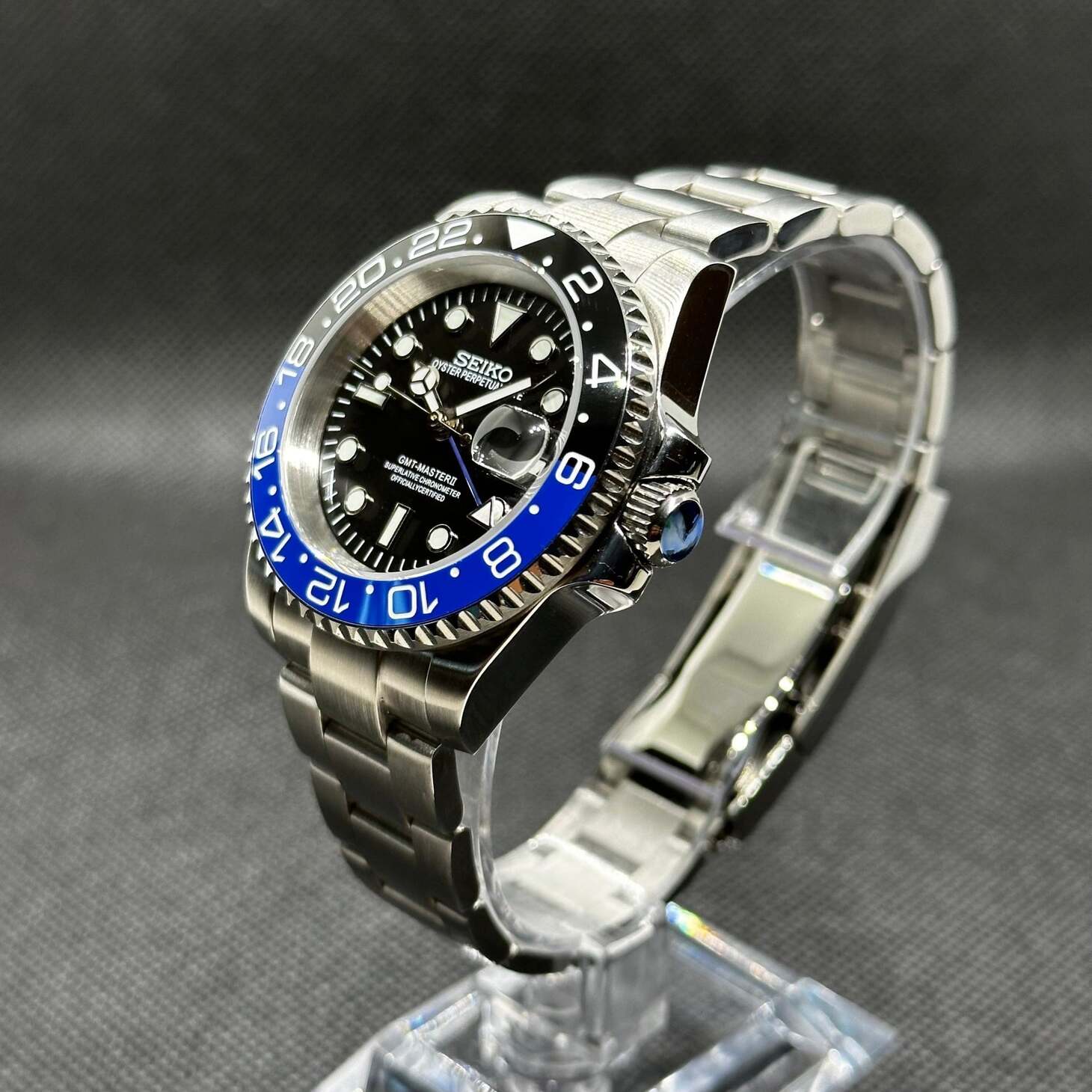 Right three quarter angle Seiko Mod GMT Batman showing stainless steel bracelet curvature and raised bezel profile