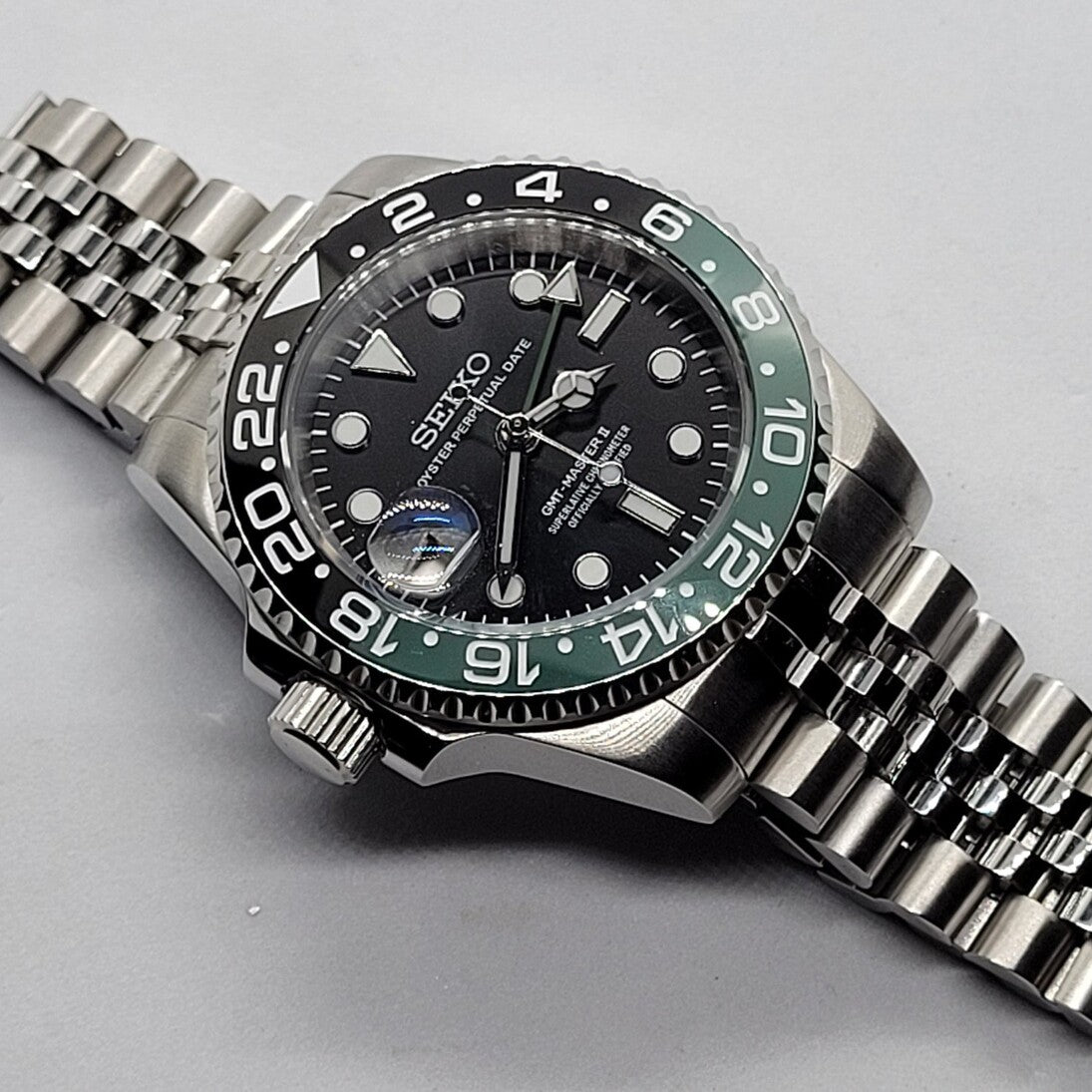 Angled close view Seiko Mod GMT Sprite highlighting dial clarity and brushed case finish