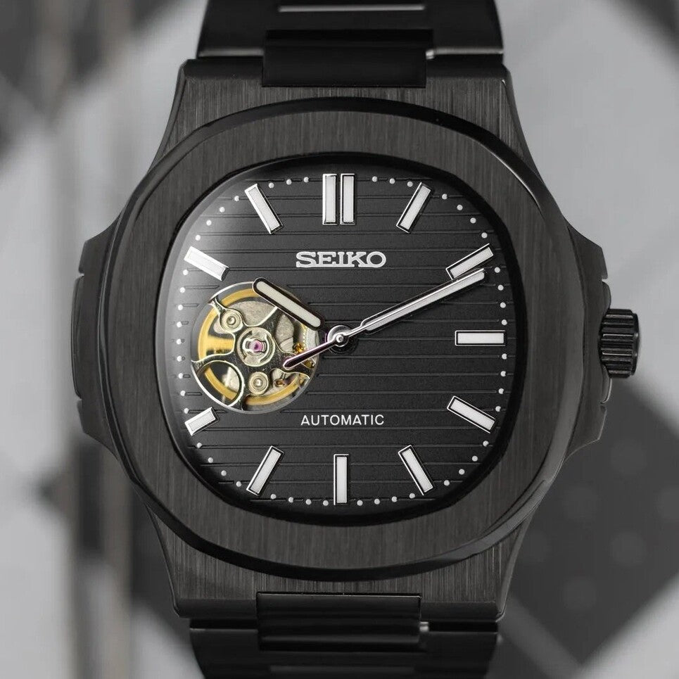 Front view Seiko Mod Nautilus All Black Open Heart showing exposed balance wheel and brushed dial