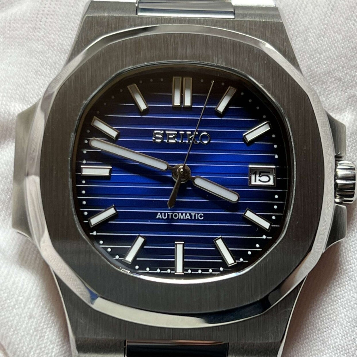 Front view of Seiko mod Nautilus royal blue edition featuring brushed bezel and horizontal striped dial