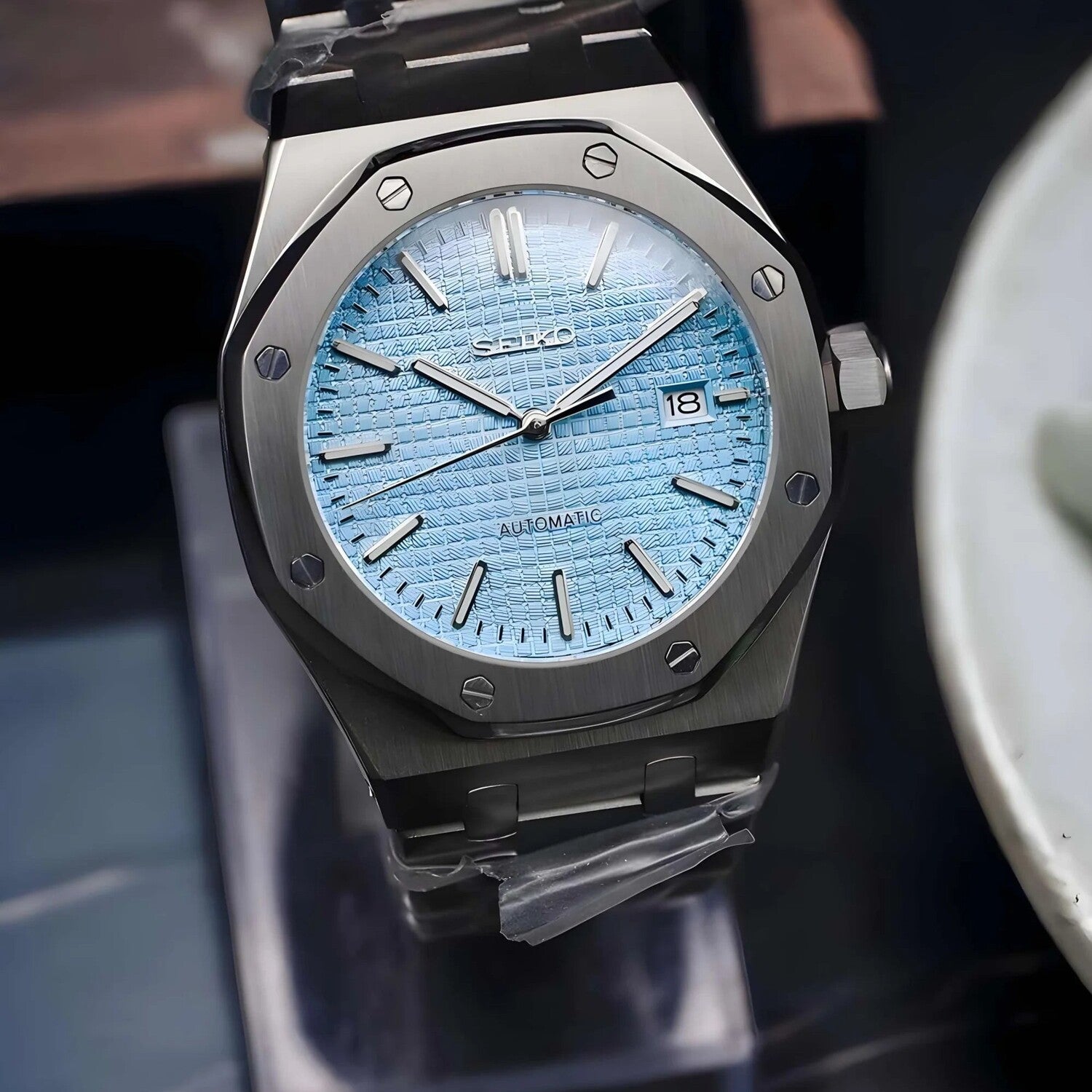 Slightly angled close up of the Seiko Mod Royal Oak automatic watch with ice blue dial, 41mm stainless steel case, and date display at three o’clock