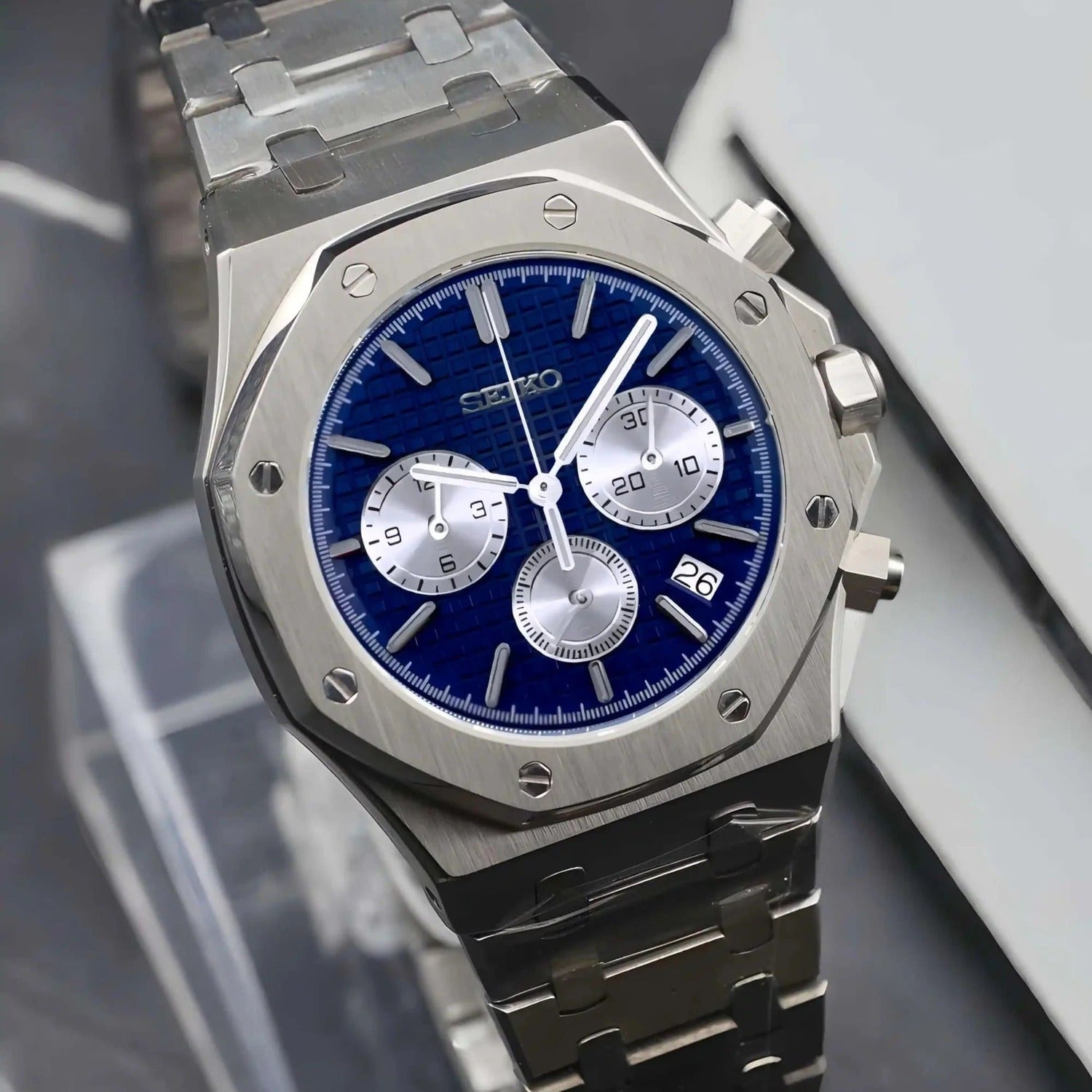 Right angled view of the Seiko Mod Royal Oak chronograph with Seiko VK63 hybrid movement, vibrant blue waffle-pattern dial, three silver subdials, brushed stainless steel case, and integrated steel bracelet